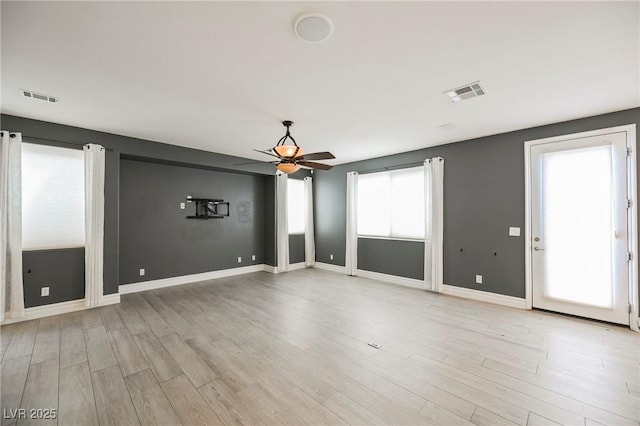 unfurnished room with ceiling fan and light wood-type flooring