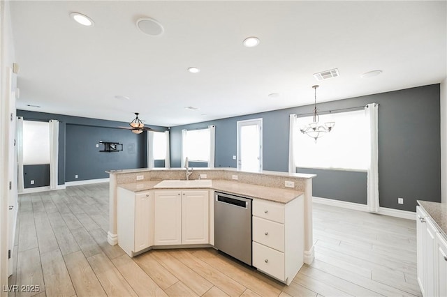 kitchen with pendant lighting, sink, light hardwood / wood-style floors, a center island with sink, and stainless steel dishwasher