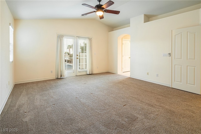 spare room featuring vaulted ceiling, light colored carpet, and ceiling fan