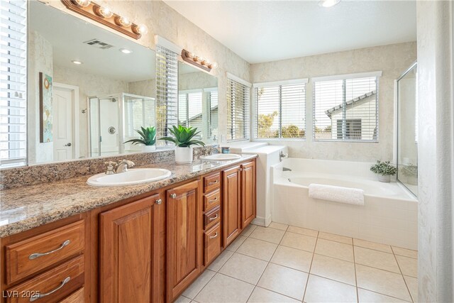 bathroom with vanity, tile patterned floors, and plus walk in shower