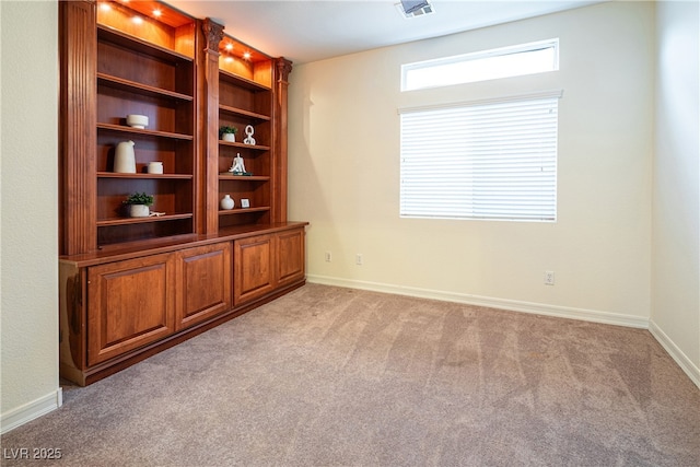 unfurnished room with light colored carpet