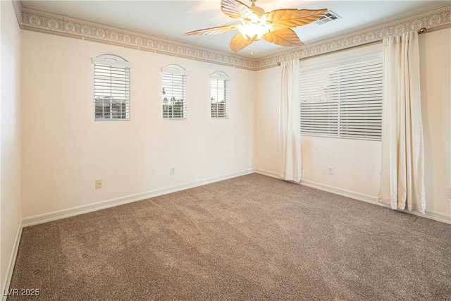 carpeted spare room with ceiling fan and ornamental molding