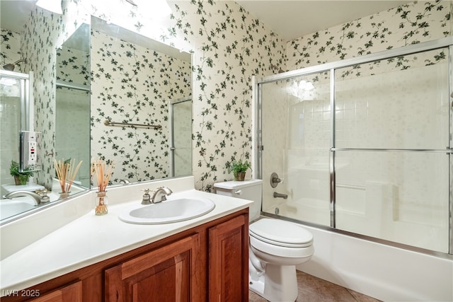 full bathroom with tile patterned flooring, vanity, combined bath / shower with glass door, and toilet