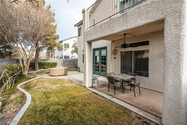 back of house with french doors, a patio area, a balcony, a hot tub, and ceiling fan