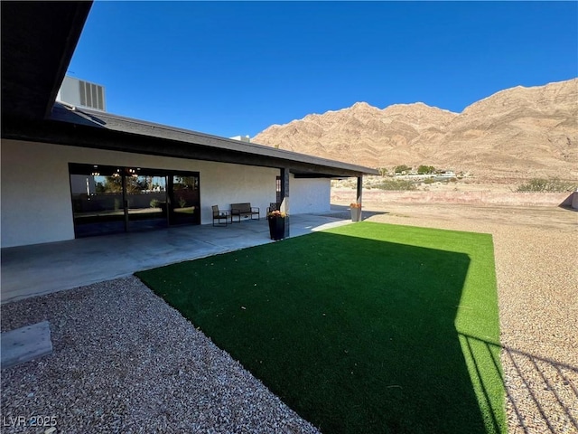 view of yard featuring a mountain view and a patio area