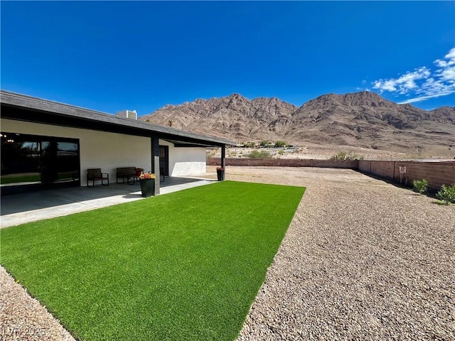 view of yard with a mountain view and a patio area