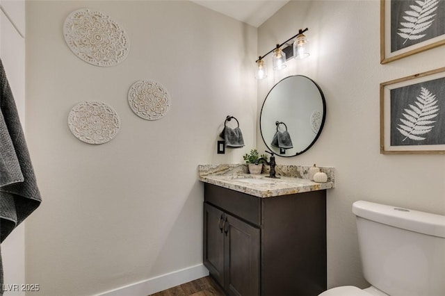 bathroom with vanity, hardwood / wood-style floors, and toilet