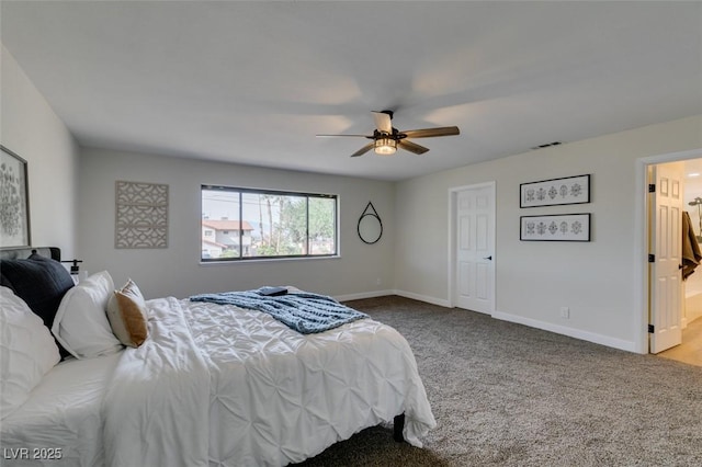 bedroom with ceiling fan, ensuite bathroom, and carpet