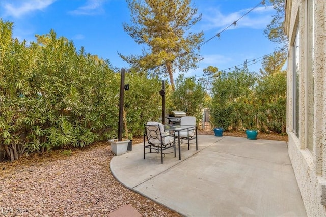 view of patio with outdoor dining space and fence