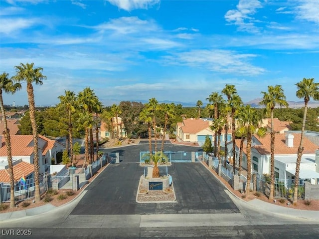 view of road featuring a residential view and curbs