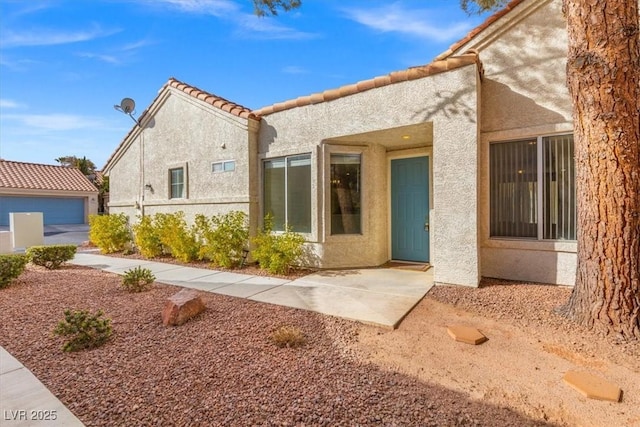 rear view of house with a garage