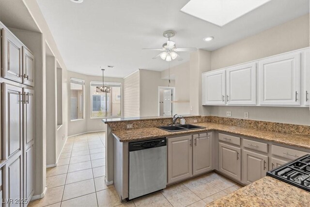 kitchen with sink, light tile patterned floors, dishwasher, white cabinetry, and kitchen peninsula