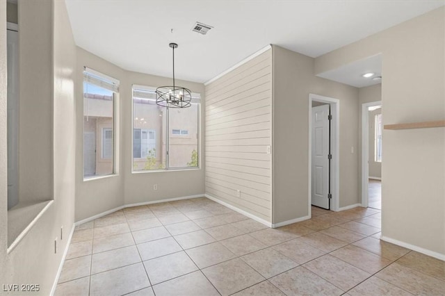 interior space with a chandelier and light tile patterned floors