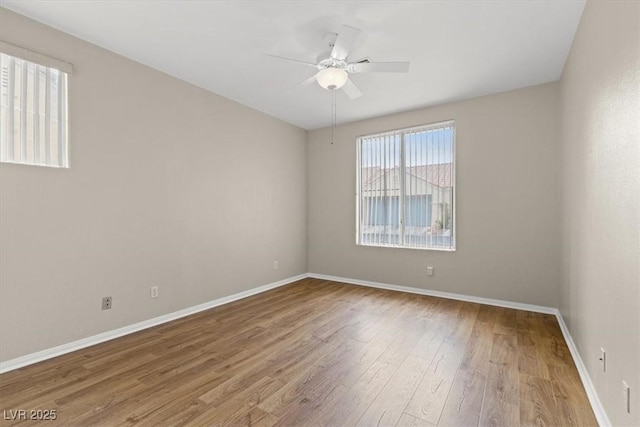 empty room featuring hardwood / wood-style flooring and ceiling fan