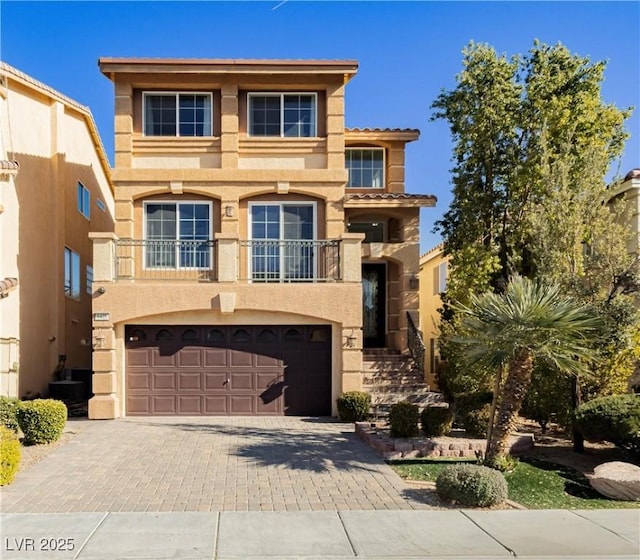 view of front of home featuring a garage and a balcony