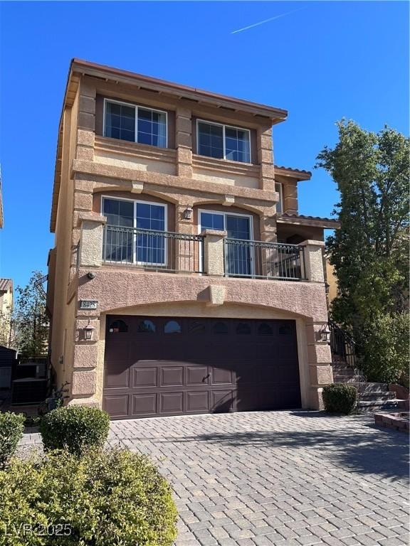 view of front of house with a garage and a balcony