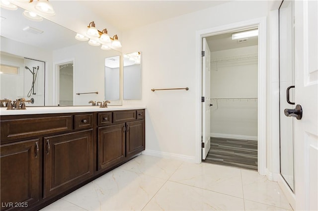 bathroom featuring vanity and an enclosed shower