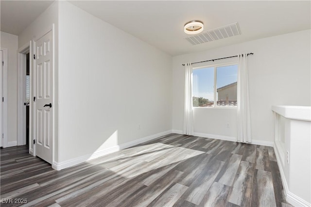 spare room with dark hardwood / wood-style floors