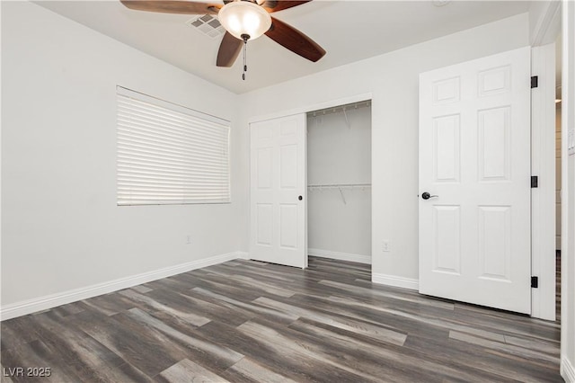 unfurnished bedroom with dark hardwood / wood-style floors, ceiling fan, and a closet