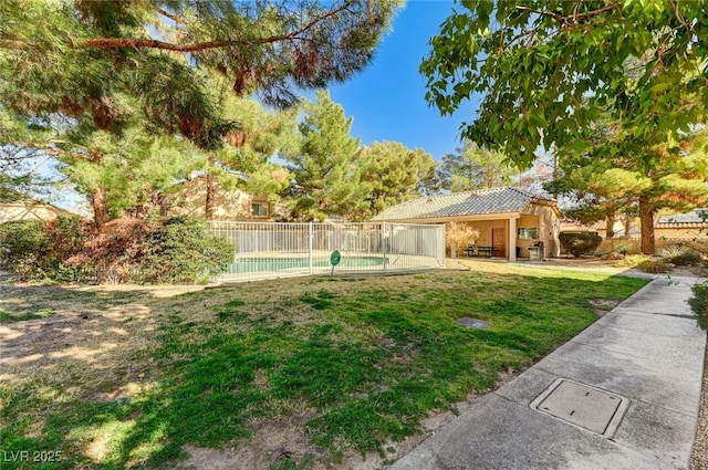 view of yard with a patio, fence, and a fenced in pool