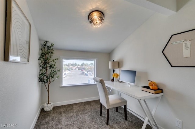 carpeted home office featuring lofted ceiling with beams