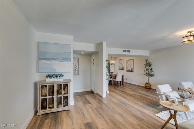 interior space featuring hardwood / wood-style floors and a notable chandelier