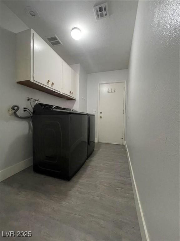 laundry area with cabinets and washing machine and dryer