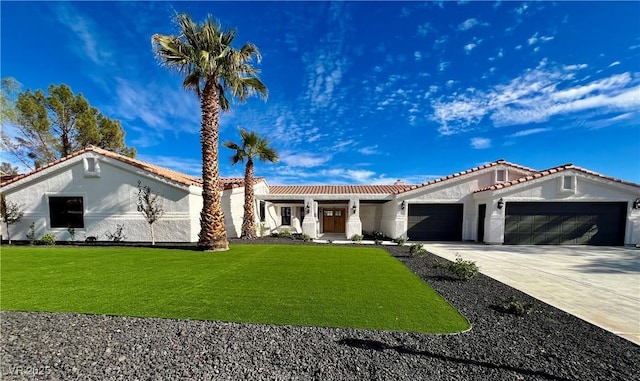 mediterranean / spanish house with a garage and a front yard