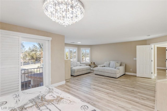 living room featuring a notable chandelier and light hardwood / wood-style flooring