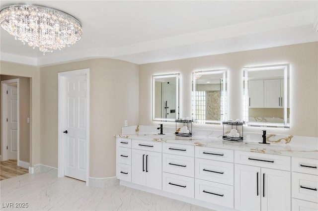 bathroom featuring vanity and a chandelier