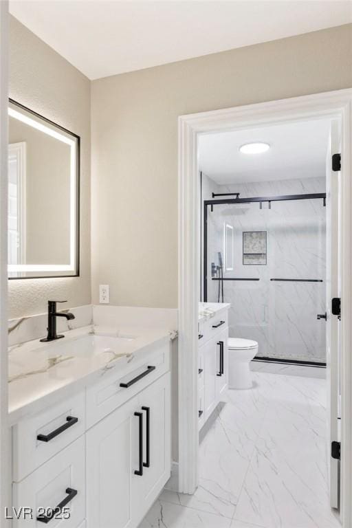 bathroom featuring vanity, toilet, and an enclosed shower