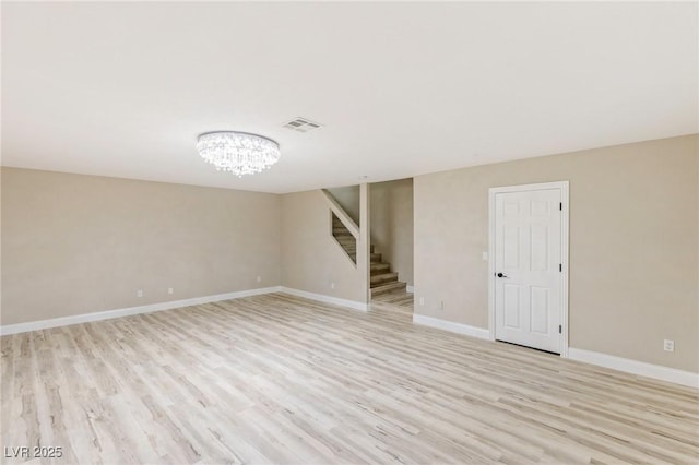 interior space featuring an inviting chandelier and light hardwood / wood-style floors