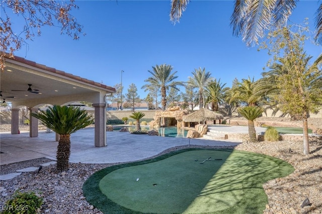 view of yard featuring ceiling fan and a patio area