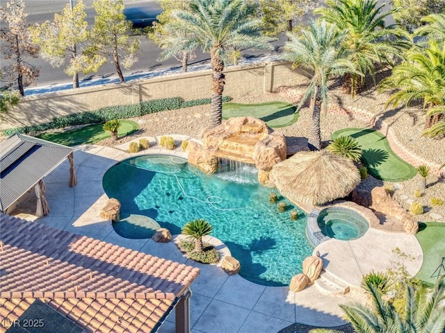 view of swimming pool featuring an in ground hot tub