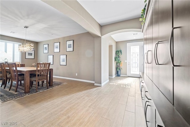 dining room with a notable chandelier and plenty of natural light