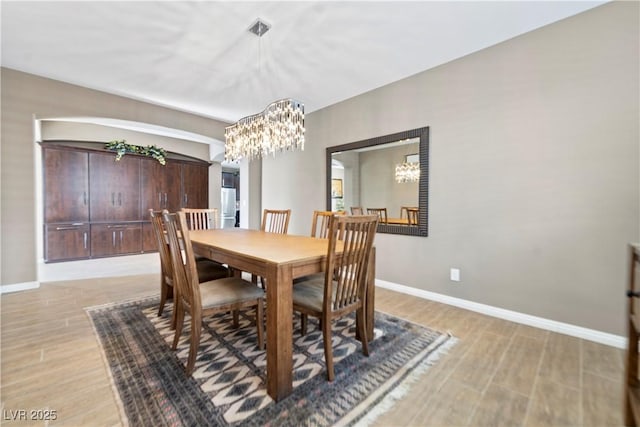 dining room featuring an inviting chandelier and light hardwood / wood-style flooring