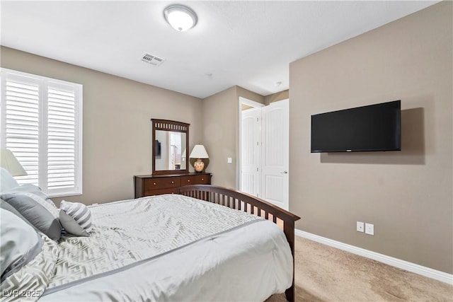 carpeted bedroom with multiple windows