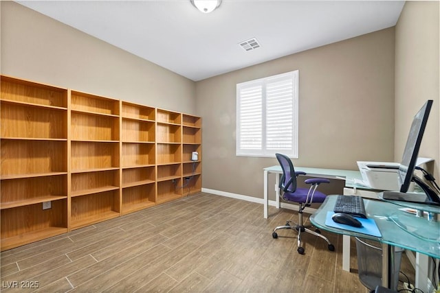 home office with hardwood / wood-style flooring