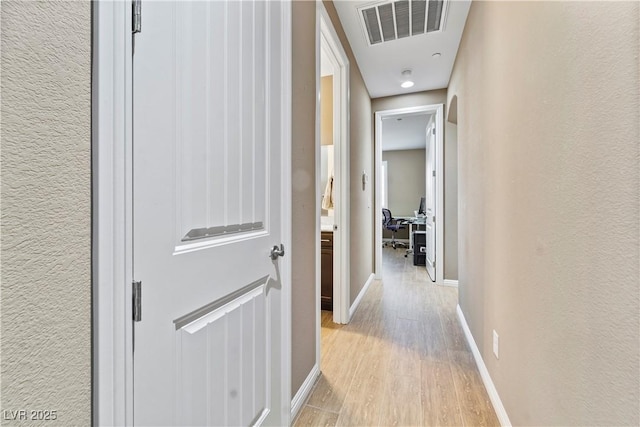 hallway with light hardwood / wood-style flooring