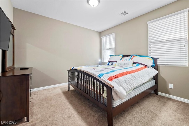 bedroom featuring light colored carpet