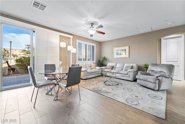 living room featuring ceiling fan and light hardwood / wood-style flooring