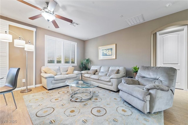 living room featuring ceiling fan and light wood-type flooring