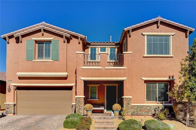 view of front of property featuring a garage and a balcony