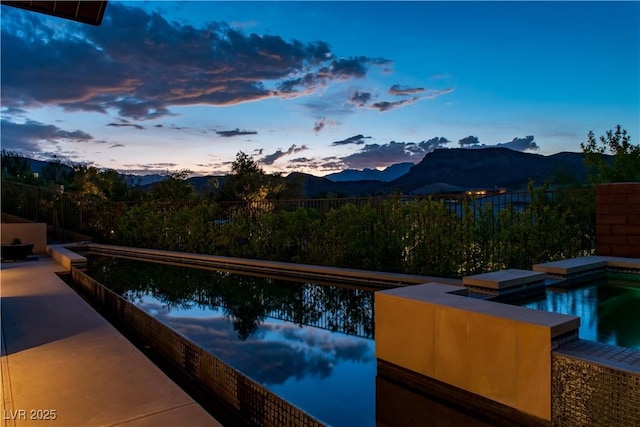 pool at dusk with a mountain view