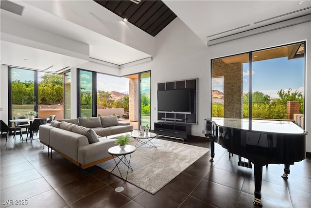 tiled living room featuring vaulted ceiling and a wall mounted AC