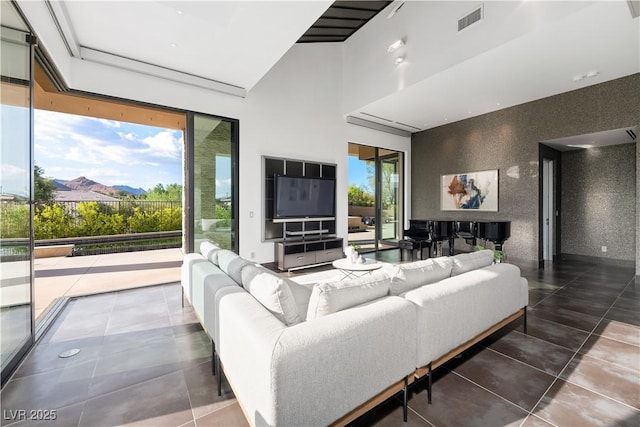 living room with a healthy amount of sunlight and tile patterned floors