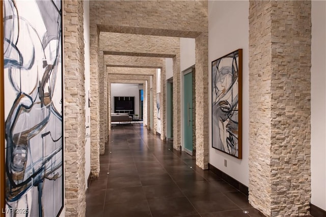 hallway featuring dark tile patterned flooring