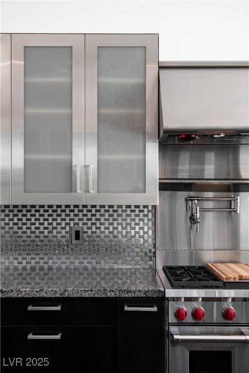 kitchen with tasteful backsplash, designer range, and stone counters