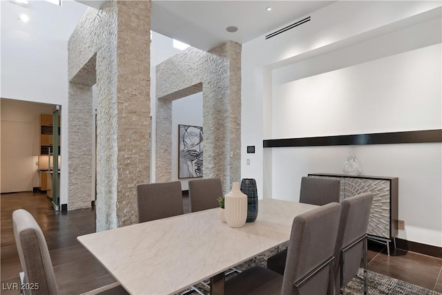 dining room with a towering ceiling