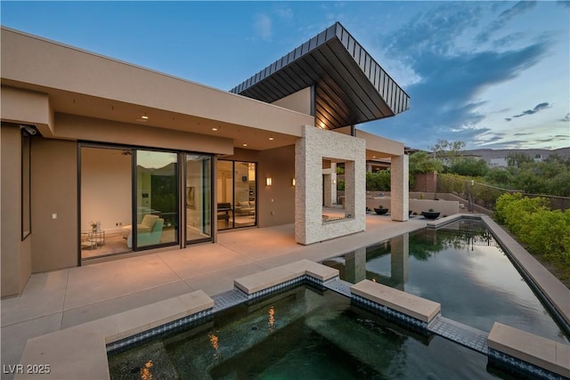 view of swimming pool featuring an in ground hot tub and a patio